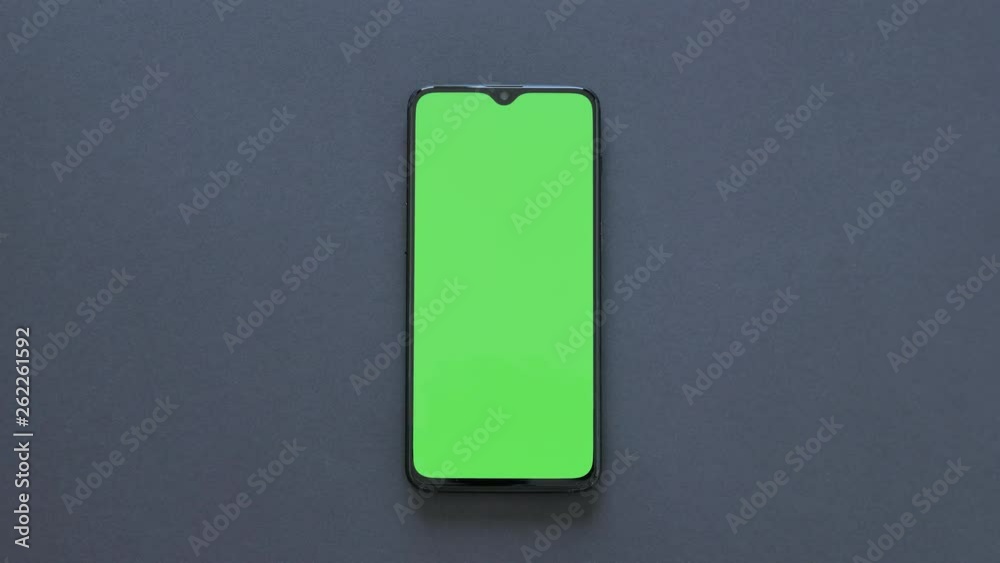 Green Screen - A modern smartphone lies on black background Green Screen - A modern smartphone lies on black background