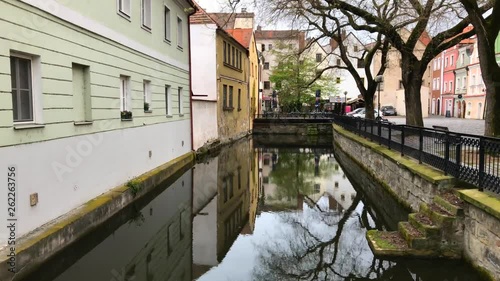 Old Europe. Pardubice. The river between the housesPalm trees and houses view. Old Europe. Pardubice. The river between the houses
