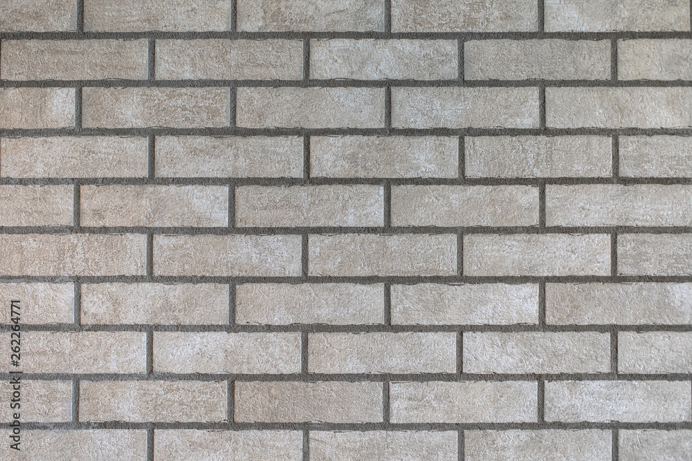 Closeup of modern neutral grey brick wall with dark seams. For pattern, texture and background Closeup of modern neutral grey brick wall with dark seams. For pattern, texture and background