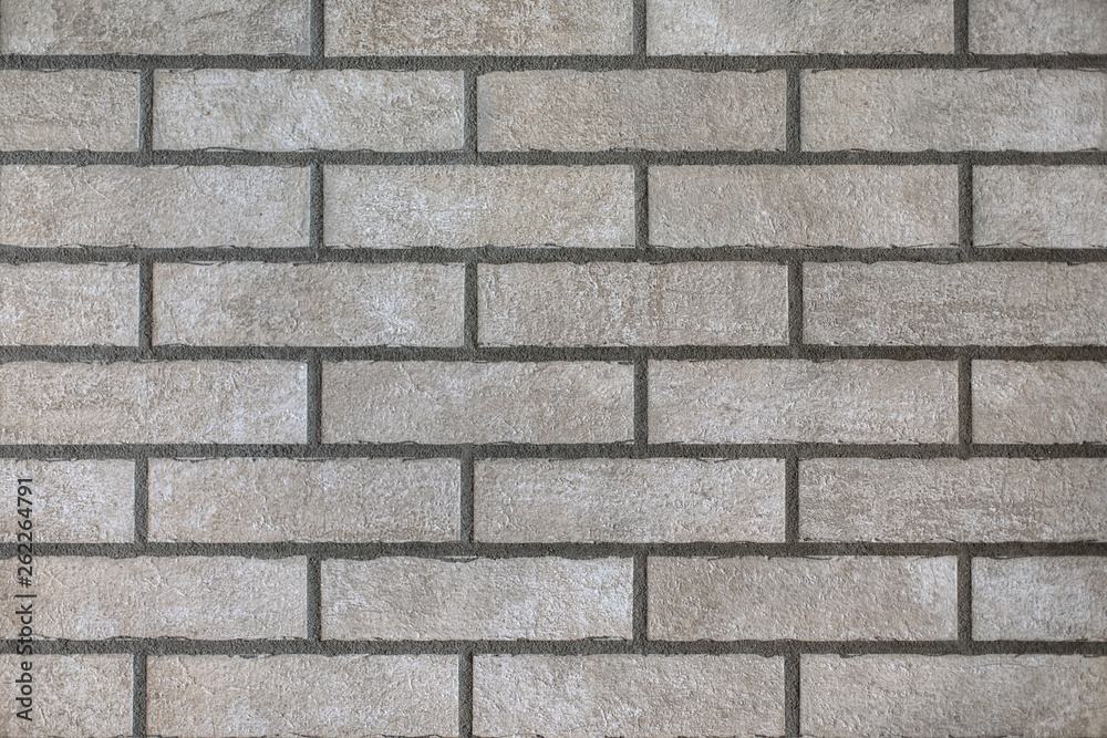 Closeup of modern neutral grey brick wall with dark seams. For pattern, texture and background Closeup of modern neutral grey brick wall with dark seams. For pattern, texture and background