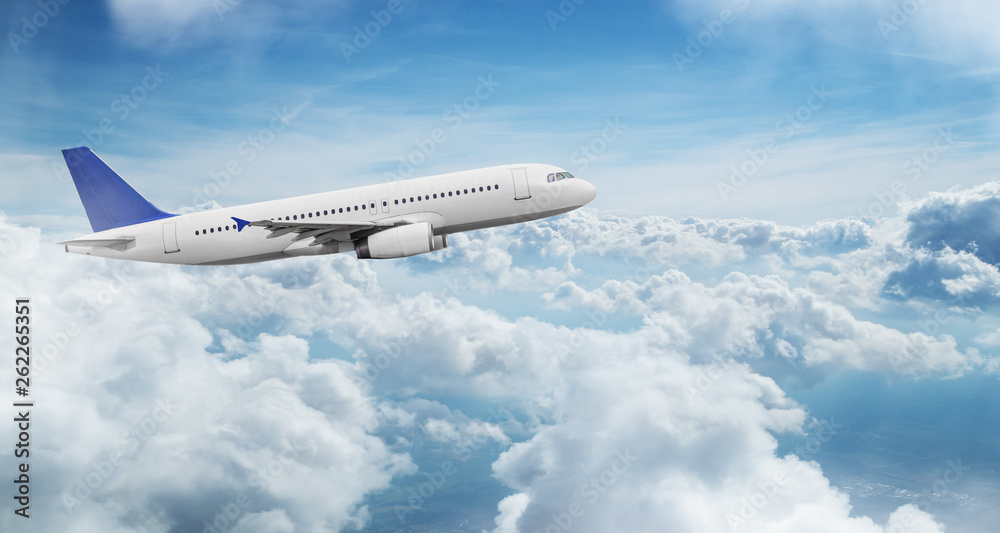 Commercial airplane jetliner flying above dramatic clouds.