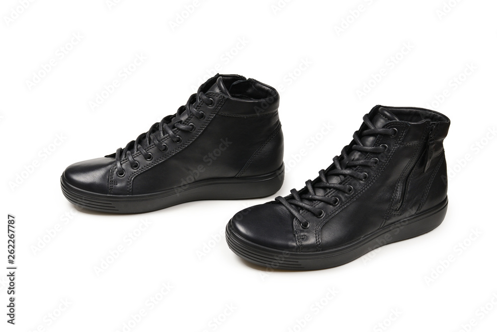 Men's black leather shoes and a black camera on a isolated on white background. Copy space. Men's black leather shoes and a black camera on a isolated on white background. Copy space.