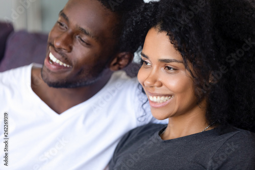 Close up happy African American couple sitting together on sofa © fizkes