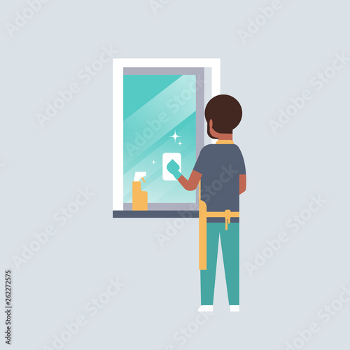 Man in gloves and apron cleaning window