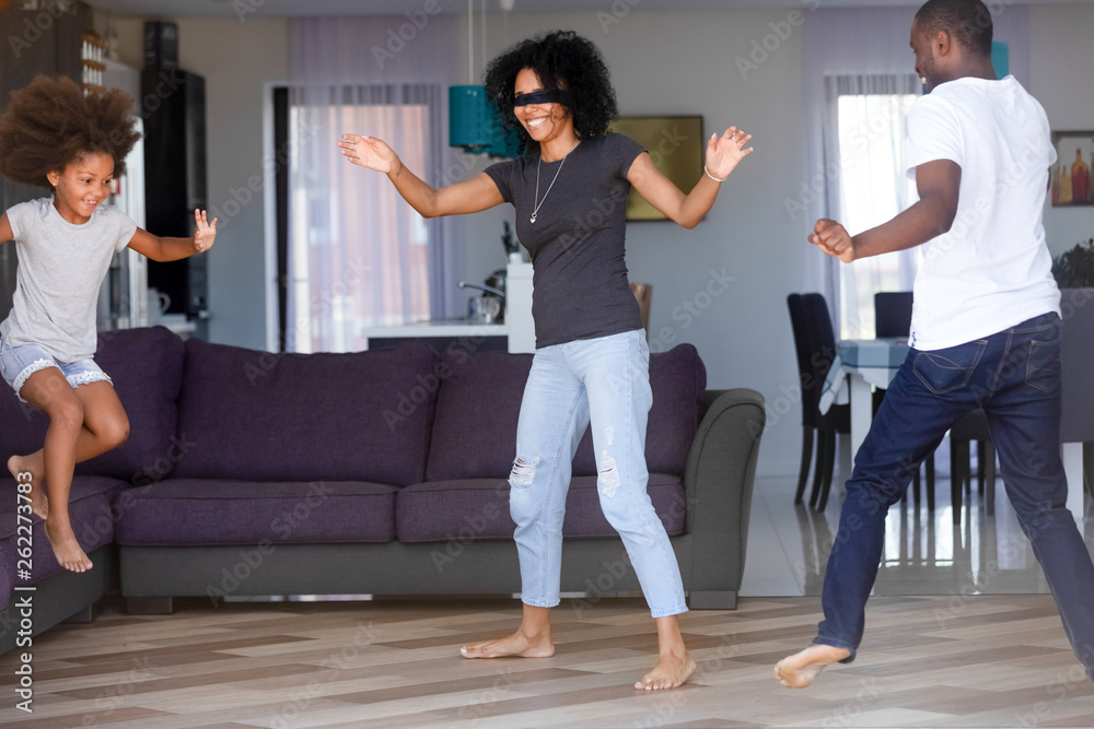 Happy African American family playing hide and seek at home Happy African American family playing hide and seek at home