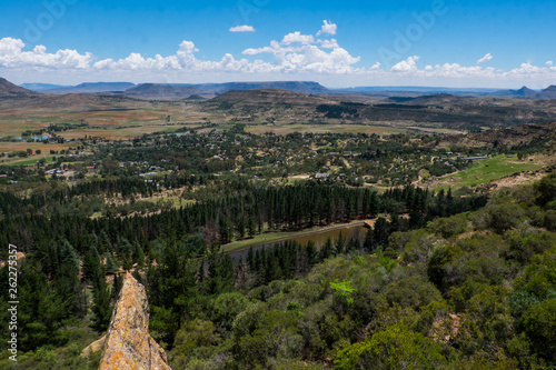 Open African landscape during day time with mountains, forest and clouds photo