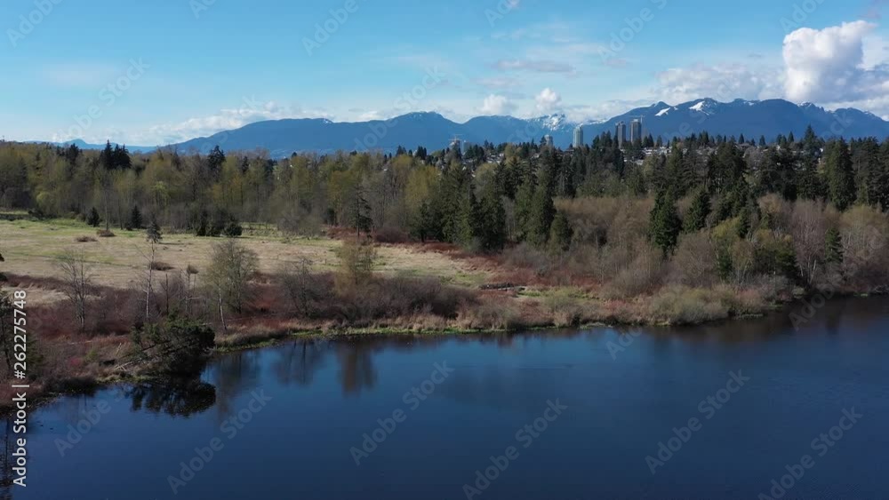 Aerial View at Mountain Lake with Blue Sky in British Columbia, Canada. 4K. Aerial View at Mountain Lake with Blue Sky in British Columbia, Canada. 4K.