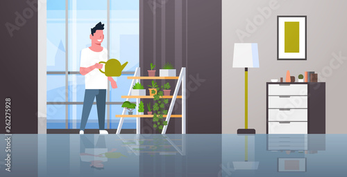 man watering potted plants on rack smiling guy holding sprinkling can doing housework concept modern living room interior male cartoon character full length horizontal