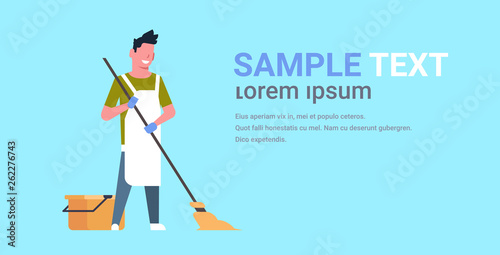 man in gloves and apron washing floor guy using mop doing housework cleaning concept flat horizontal copy space blue background full length