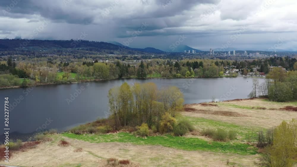 Aerial View at Mountain Lake with Dramatic Clouds in British Columbia, Canada. 4K. Aerial View at Mountain Lake with Dramatic Clouds in British Columbia, Canada. 4K.