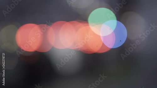 Abstract bokeh balls which show out of focus cars on a street with different colours and lights