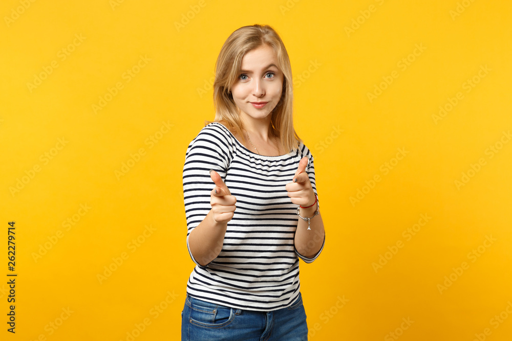 Portrait of confident young woman in striped clothes looking pointing index fingers on camera isolated on yellow orange wall background. People sincere emotions, lifestyle concept. Mock up copy space. Portrait of confident young woman in striped clothes looking pointing index fingers on camera isolated on yellow orange wall background. People sincere emotions, lifestyle concept. Mock up copy space.