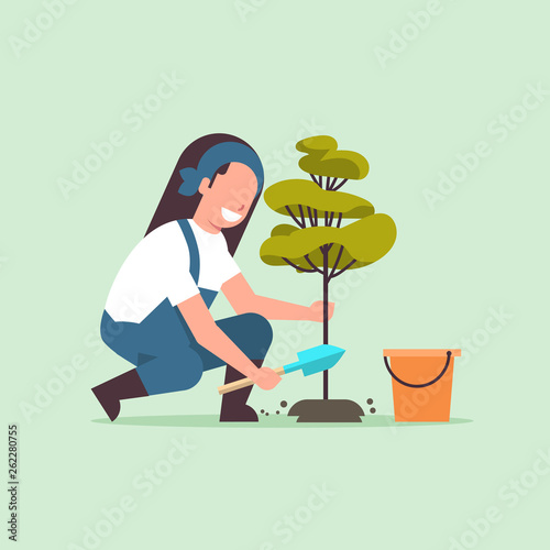 female farmer planting young tree gardener woman digging soil working in garden agricultural gardening concept flat full length