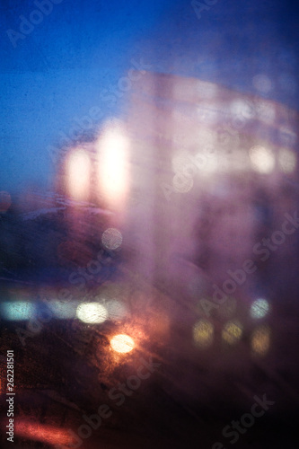 Blurred background with lights of the evening city through the window