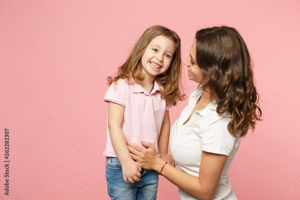 Woman in light clothes have fun with cute child baby girl. Mother, little kid daughter isolated on pastel pink wall background, studio portrait. Mother's Day, love family, parenthood childhood concept Woman in light clothes have fun with cute child baby girl. Mother, little kid daughter isolated on pastel pink wall background, studio portrait. Mother's Day, love family, parenthood childhood concept