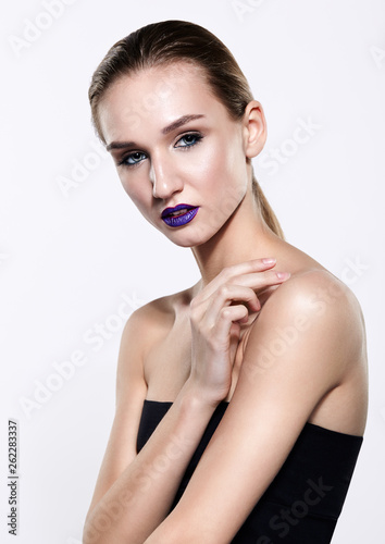 Beauty portrait of young woman with violet lips makeup