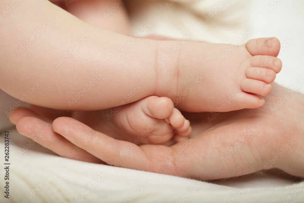 Parent holding in the hands feet of newborn baby Parent holding in the hands feet of newborn baby