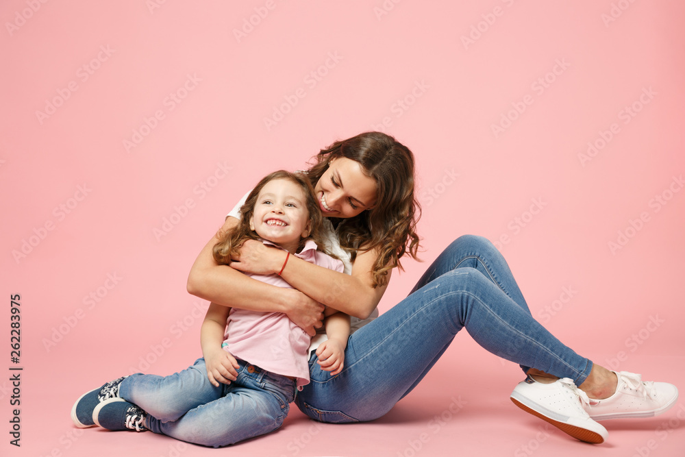 Woman in light clothes have fun with cute child baby girl. Mother, little kid daughter isolated on pastel pink wall background, studio portrait. Mother's Day, love family, parenthood childhood concept Woman in light clothes have fun with cute child baby girl. Mother, little kid daughter isolated on pastel pink wall background, studio portrait. Mother's Day, love family, parenthood childhood concept