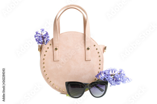  round female handbag, sunglasses and bouquet of flowers