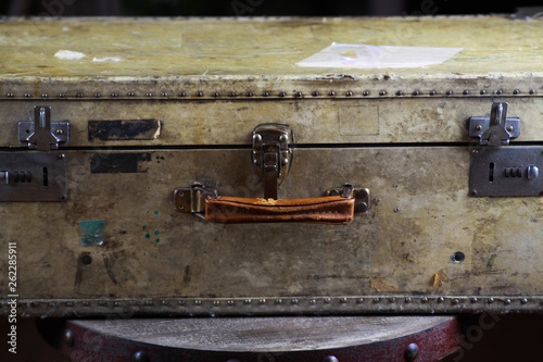 Close up of isolated old used suitcase with rivets, leather grip and combination locks