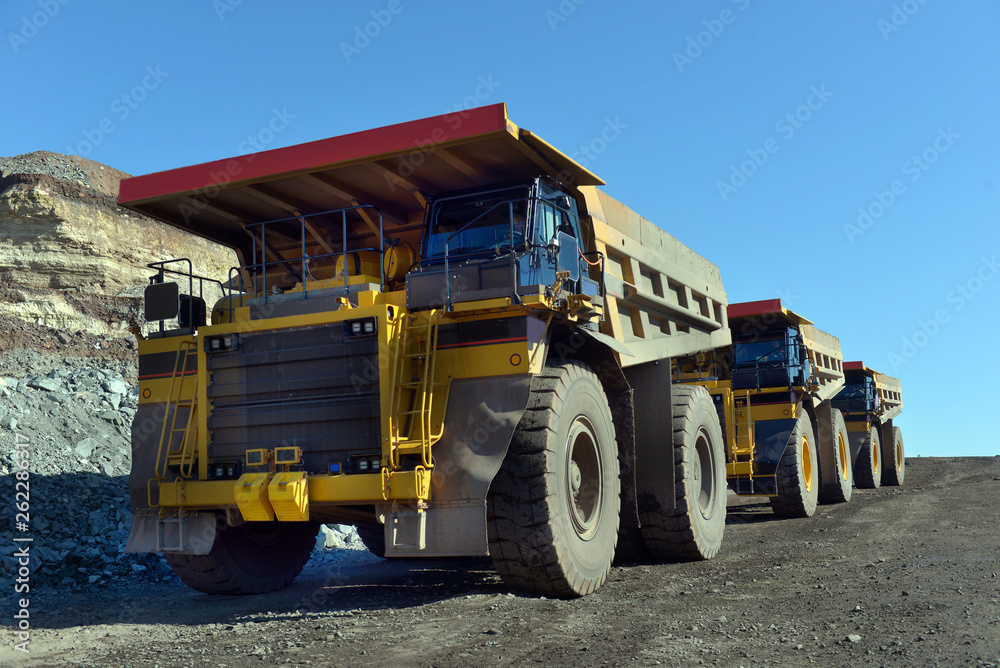 Obraz premium Large quarry dump truck. Loading the rock in the dumper. Loading coal into body work truck