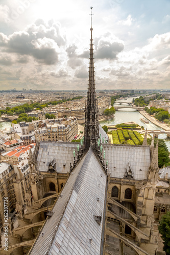 Notre Dame Cathedral and Seine River - View of the spire, roof, and flying buttresses of Notre Dame Cathedral, with the Seine River in the background. Paris, France