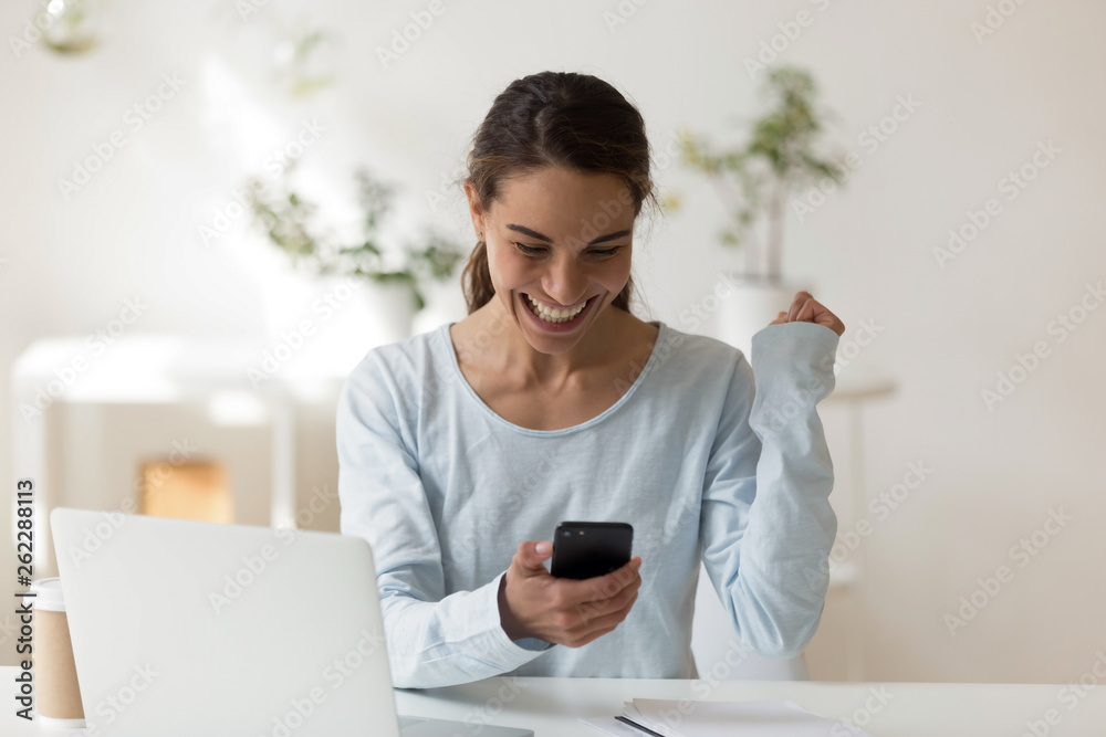 Happy woman looking at phone screen smiling Happy woman looking at phone screen smiling