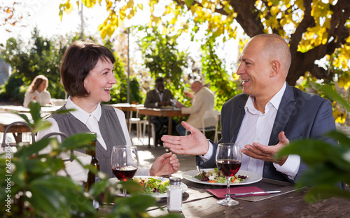 Couple in love eating dinner at restaurant summer terrace