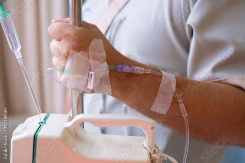 Close-up. Male hand with a dropper during chemotherapy in a hospital. Hand with a dropper. Health is a topic of health and healing
