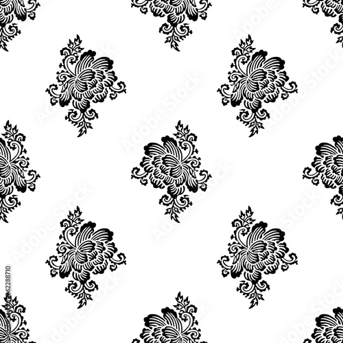 Seamless woodblock printed paisley pattern. Traditional oriental Indian ethnic ornament with peony flowers, black on white background. Textile design.