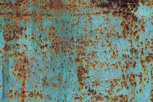 rusty metal background, old piece of metal painted turquoise covered with rust