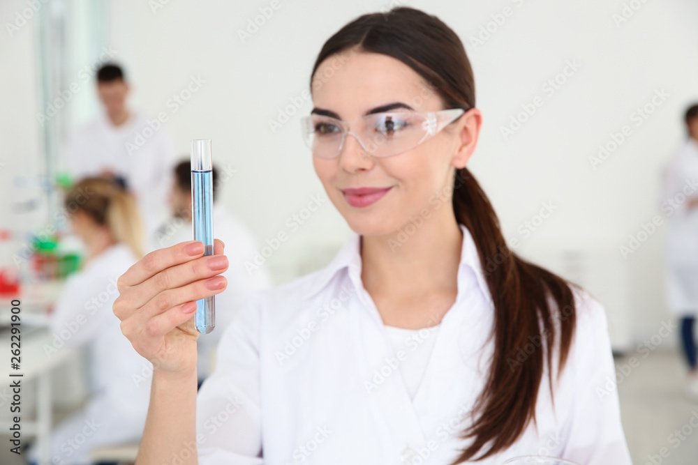 Portrait of medical student with test tube in modern scientific laboratory Portrait of medical student with test tube in modern scientific laboratory