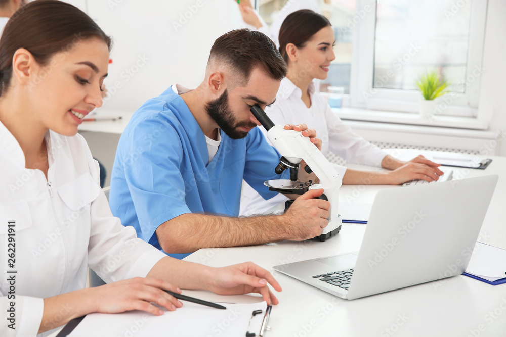 Medical students working in modern scientific laboratory Medical students working in modern scientific laboratory