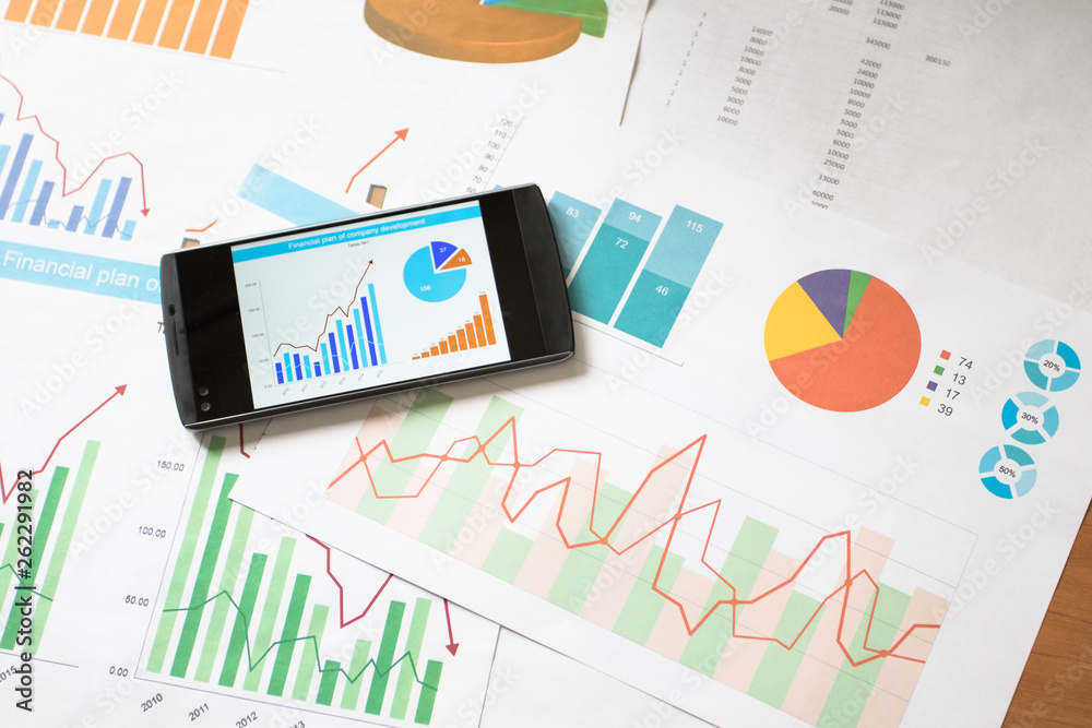 Businessman working data chart report marketing research development planning management strategy analysis financial accounting on phone. Businessman working data chart report marketing research development planning management strategy analysis financial accounting on phone.
