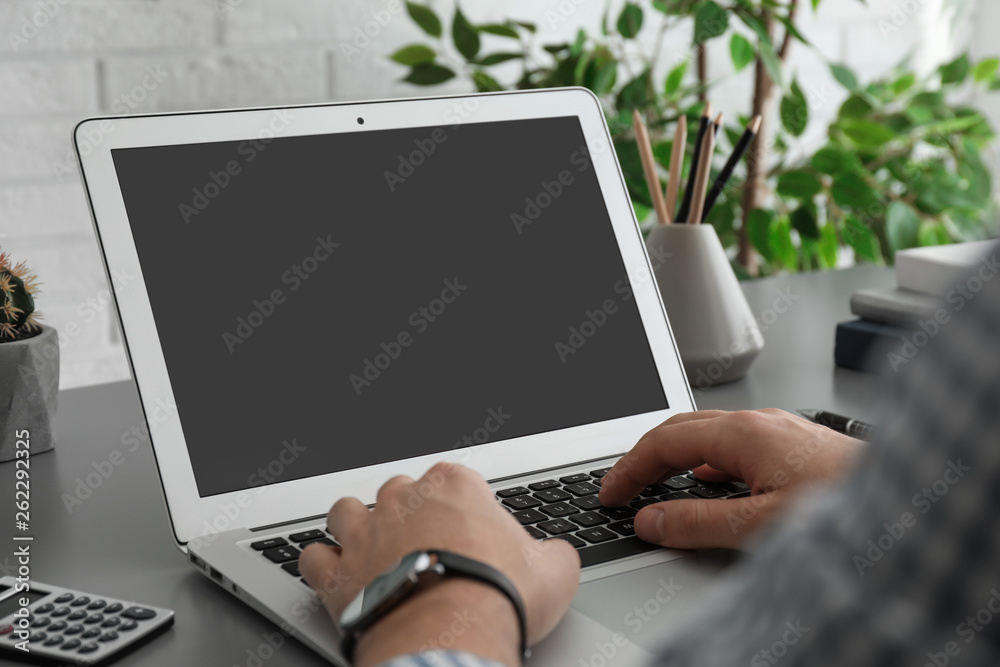 Man working with laptop at table, closeup. Space for design Man working with laptop at table, closeup. Space for design