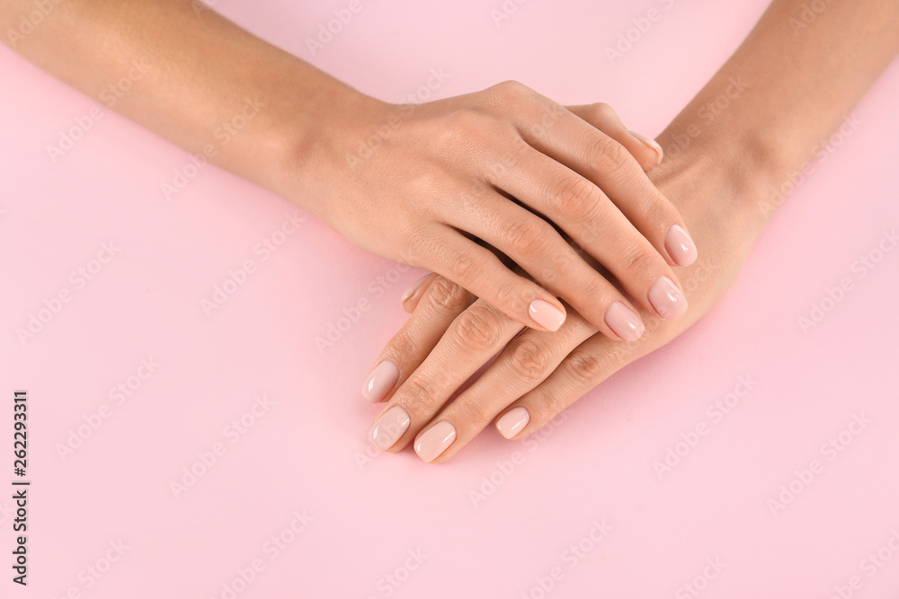 Closeup view of woman with beautiful hands on color background. Spa treatment Closeup view of woman with beautiful hands on color background. Spa treatment