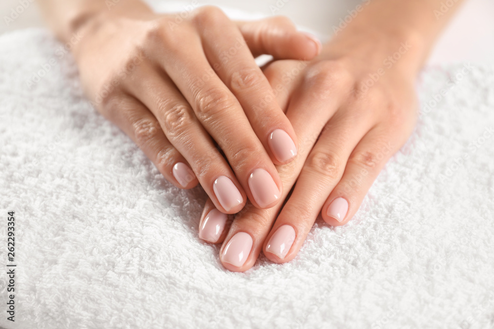 Closeup view of beautiful female hands on towel. Spa treatment