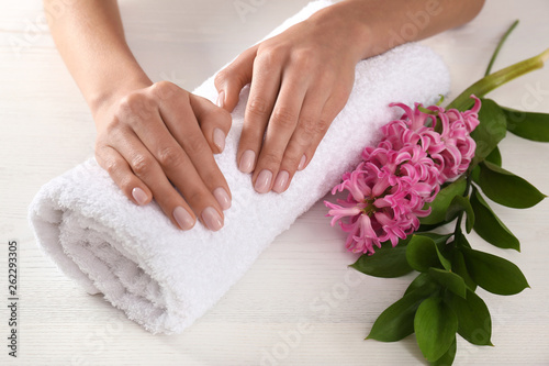 Closeup view of woman with beautiful hands at table. Spa treatment