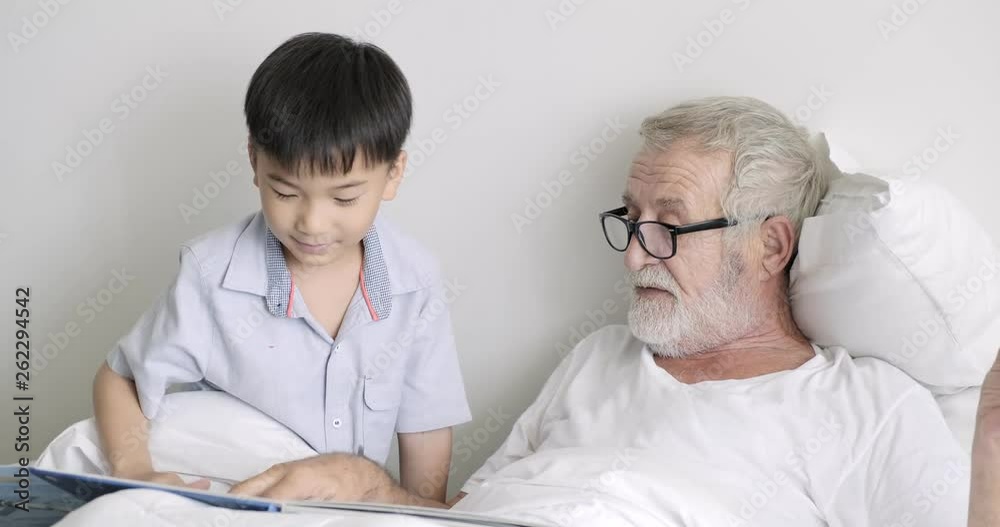 Grad Father Senior grand father with grand son in bed together. White senior ...