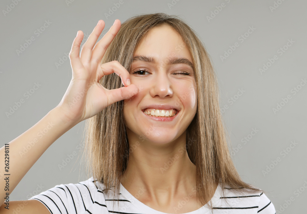 Beautiful woman using fingers to show zero, studio Beautiful woman using fingers to show zero, studio