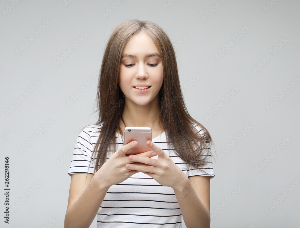 young woman with long hair, holds modern cell phone young woman with long hair, holds modern cell phone