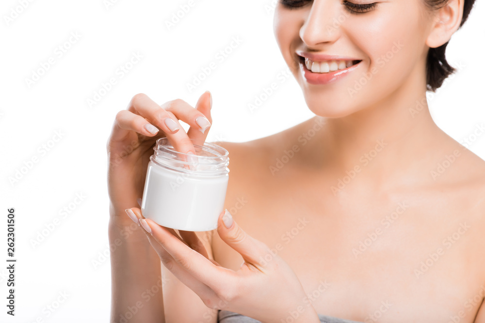 cropped view of cheerful pretty woman holding container with cosmetic cream isolated on white cropped view of cheerful pretty woman holding container with cosmetic cream isolated on white
