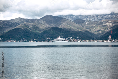 Beautiful view of the mountains and the sea with a ship in Montenegro near the coastal city of Tivat.