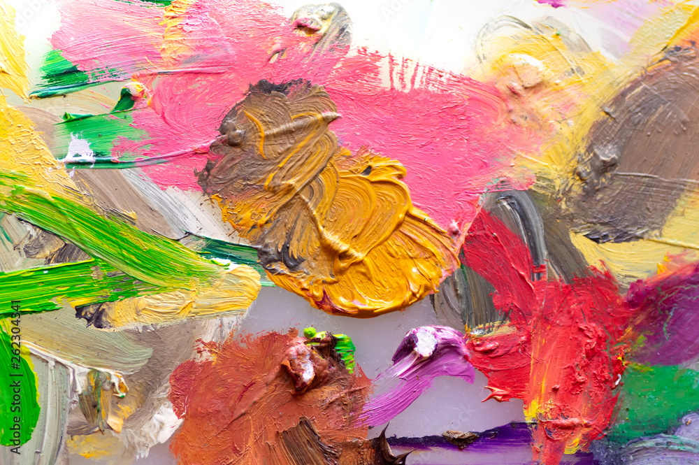 Background image of bright oil paint on the palette. Close-up, abstraction.