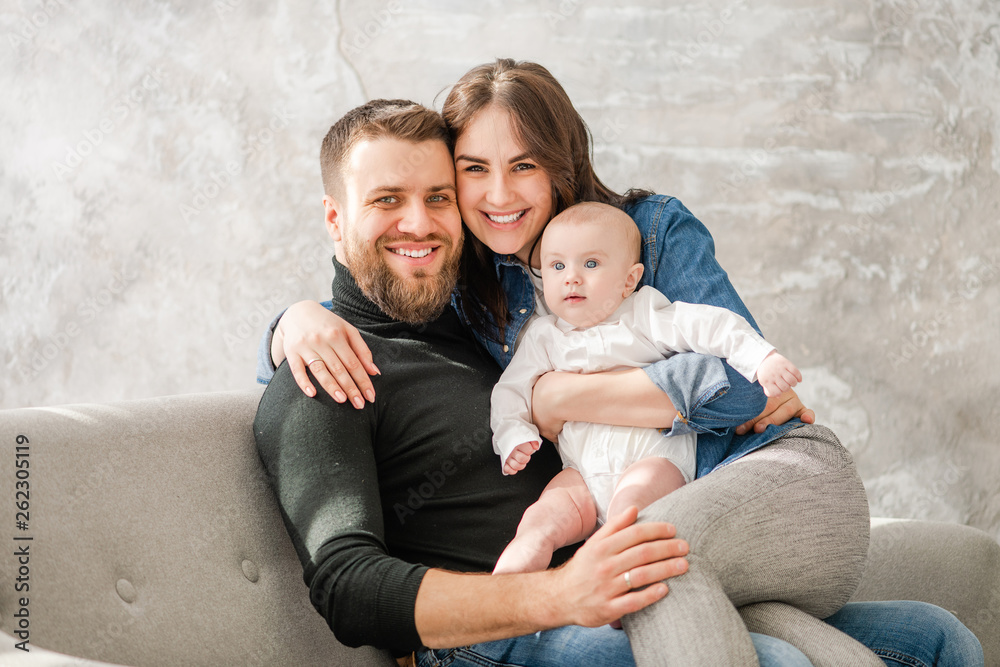 Happy family with baby sit at sofa Happy family with baby sit at sofa