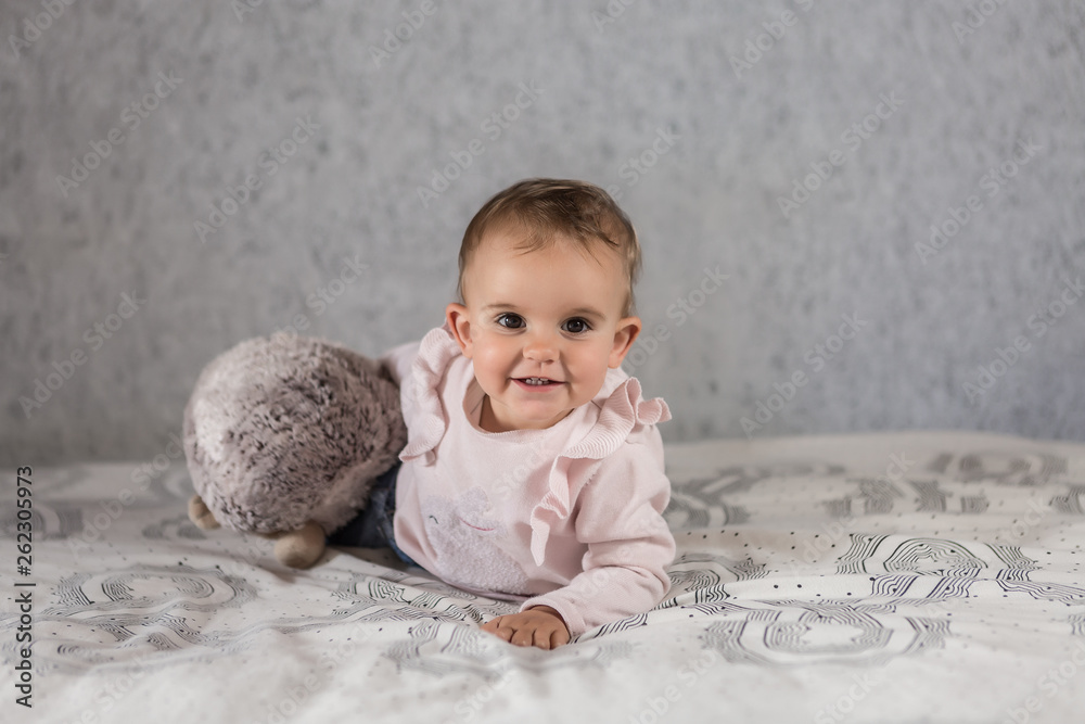 Fototapeta premium Little blond girl lyng on the bed