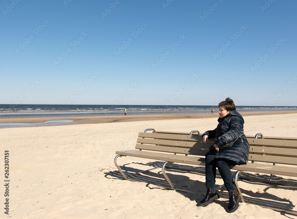 The girl on the bench at the sea