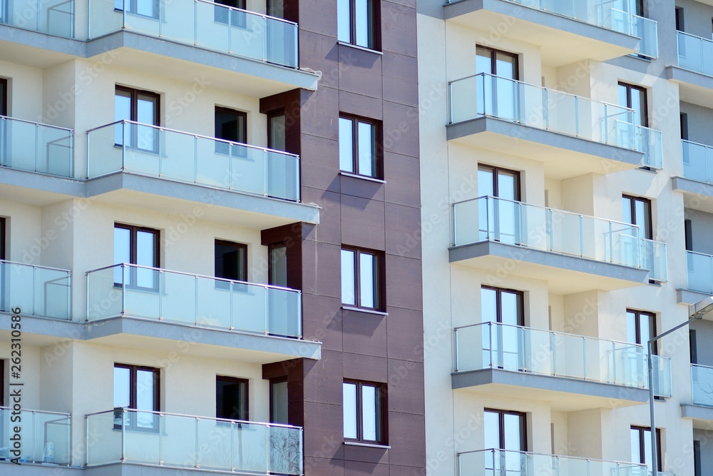 Modern apartment buildings on a sunny day with a blue sky. Facade of a modern apartment building Modern apartment buildings on a sunny day with a blue sky. Facade of a modern apartment building
