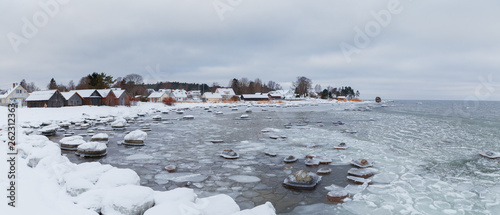 Ice-covered rocks on the shore of the Baltic Sea. Kasmu village, Estonia, winter daytime.