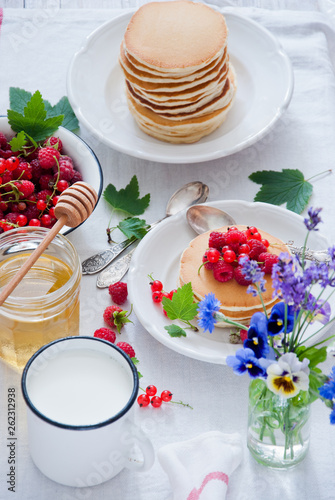 Homemade Pancakes with fresh red berries and honey